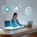 A headset-wearing rep types on a slim laptop while floating chat, analytics, and 24_7 clock icons orbit; concept of AI in customer-service